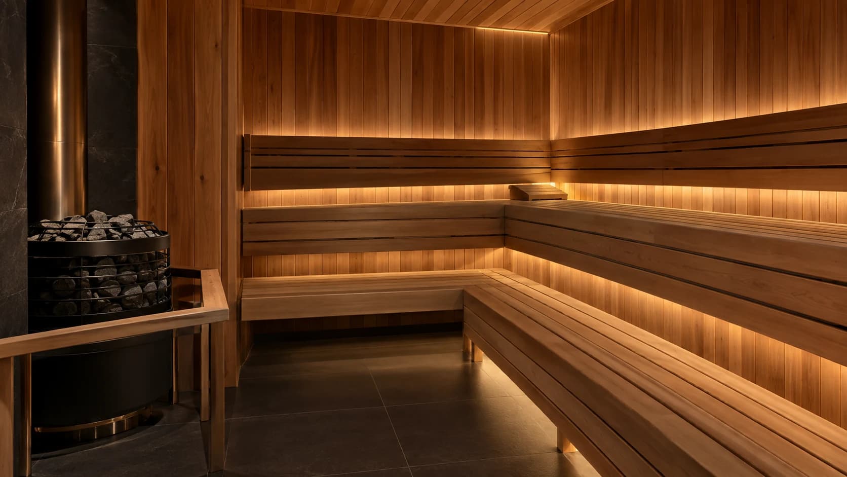 Cedar-lined sauna with tiered timber benches and a stone heater.
