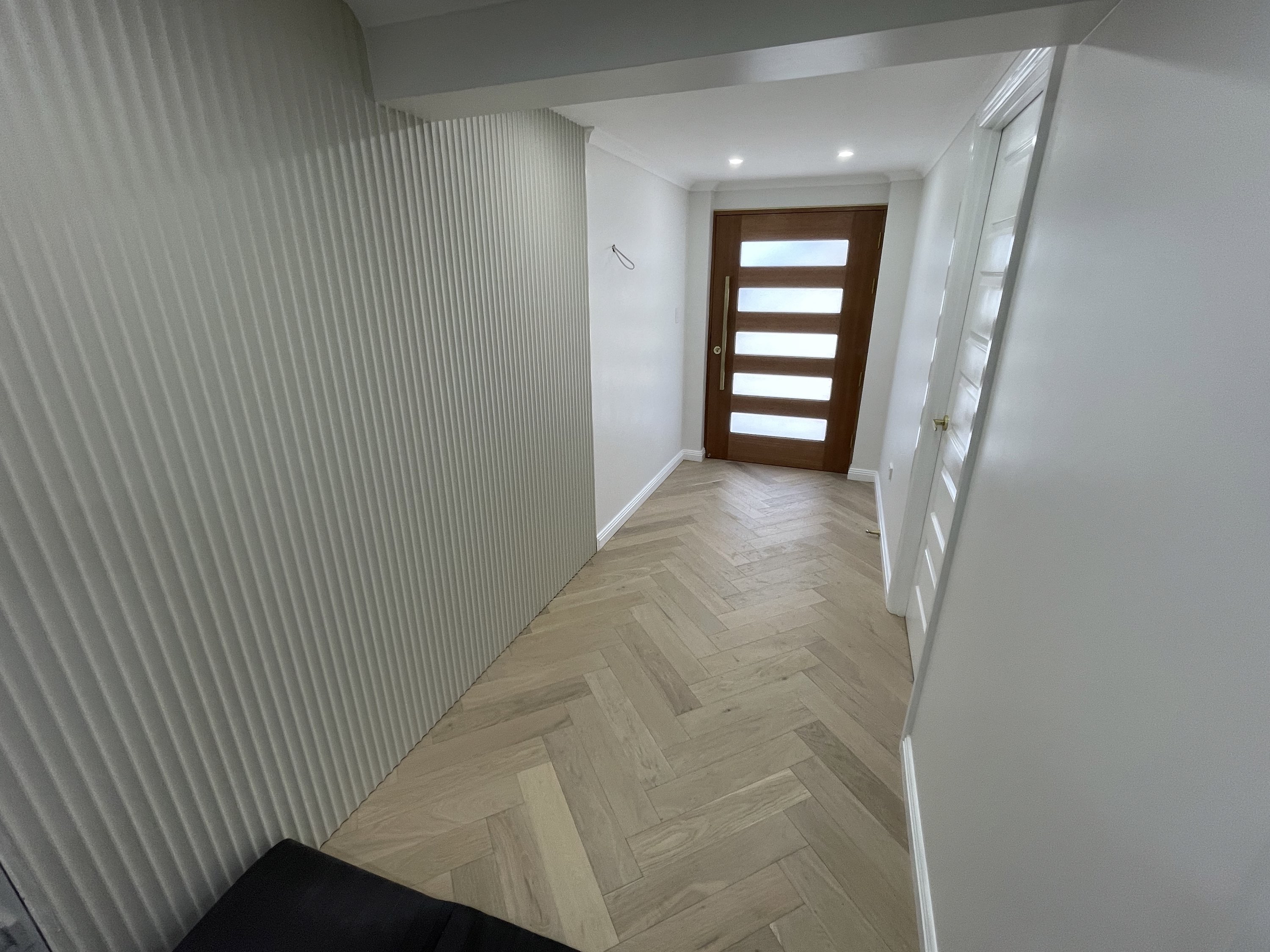 Feature wall and herringbone flooring completed by Pro Build Carpenter